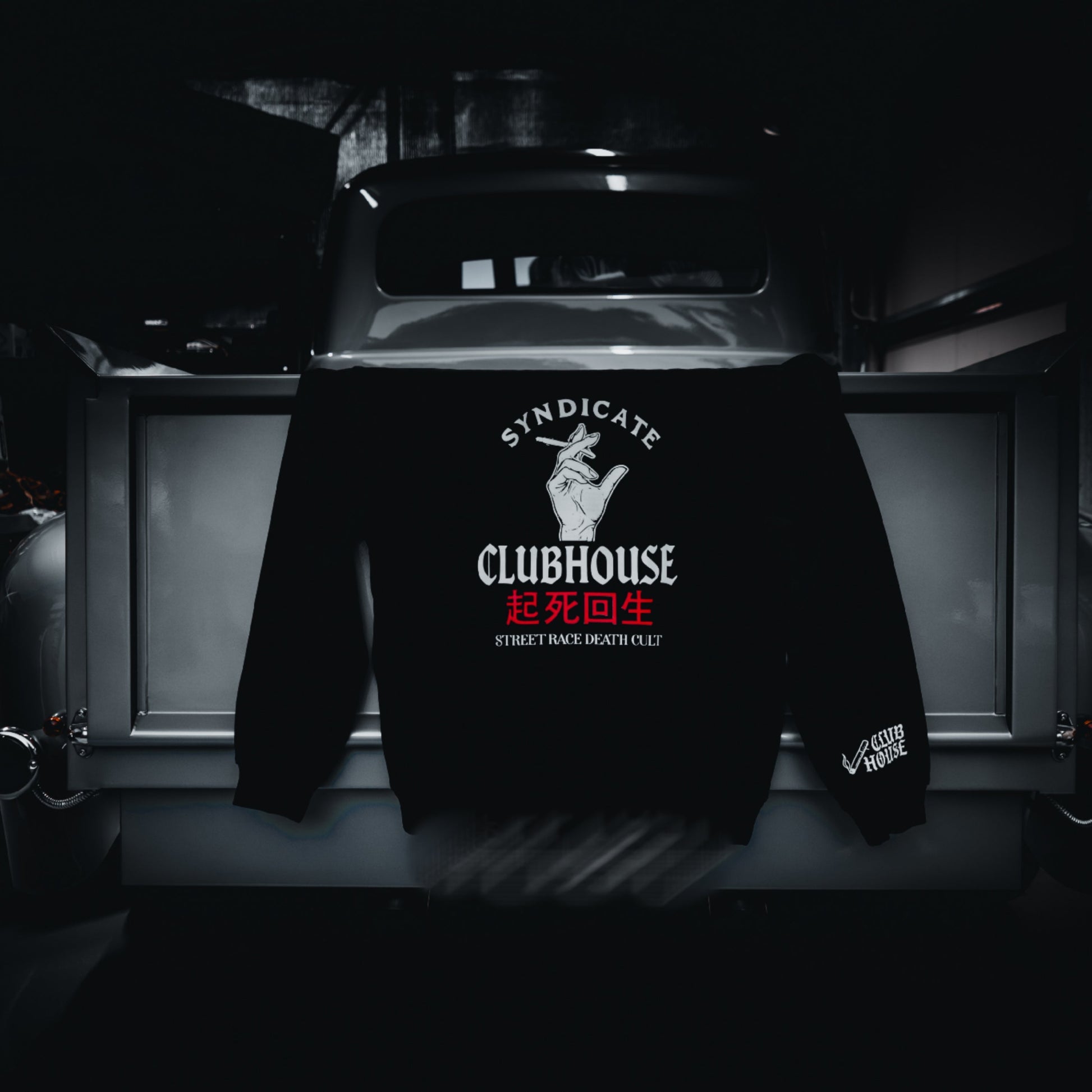 Black hoodie with 'Syndicate Clubhouse' logo on a dark background