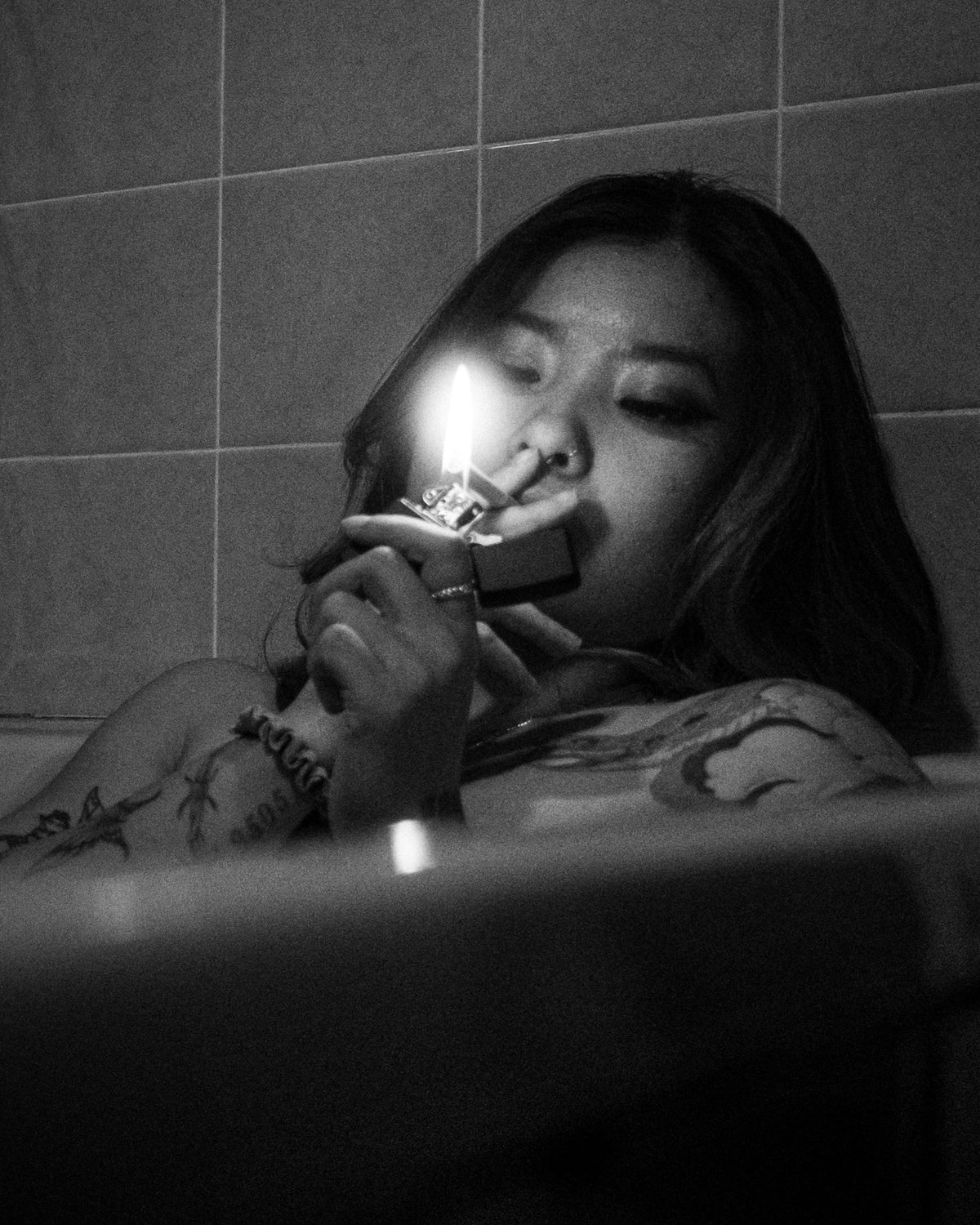Clubhouse Works engraved Zippo lighter being used in a black and white lifestyle photo